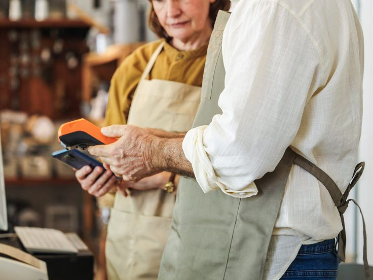 A merchant taking a card payment in-store