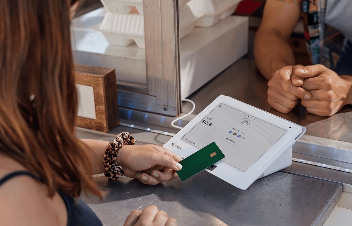 A customer inserting a chip card into a Clover terminal